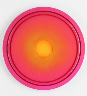 a large reddish circular painting with reverberating shades of pink, orange, and gold, like a sunset from a birds-eye view